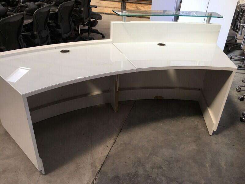 White curved reception desk
