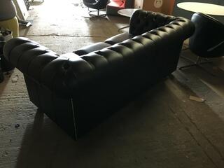 Black leather Chesterfield-style wingback armchairs